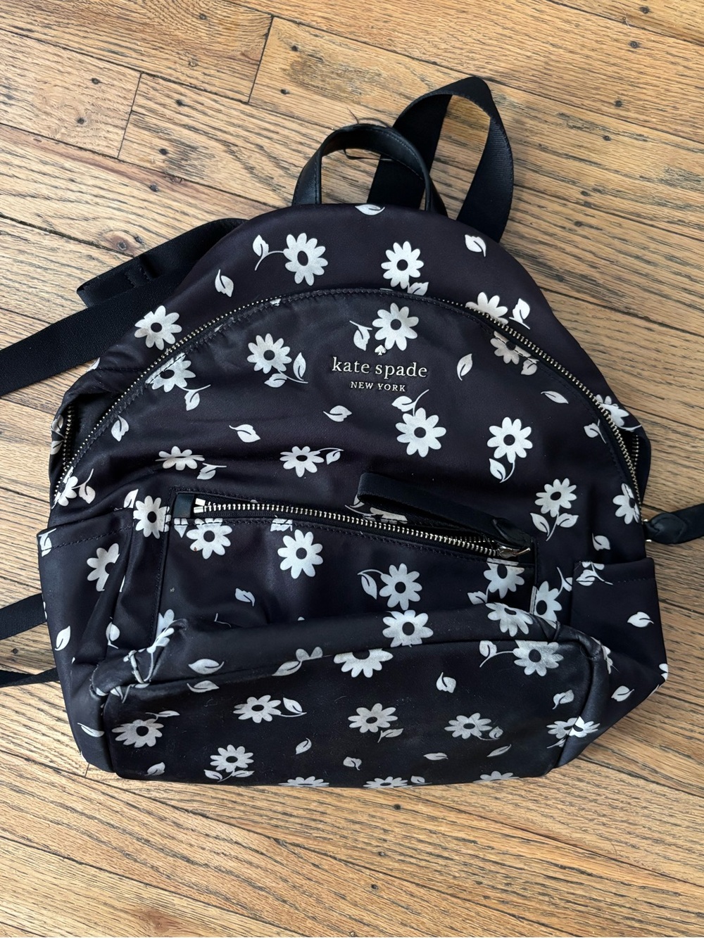 Damaged kate spade black backpack with white daisy print